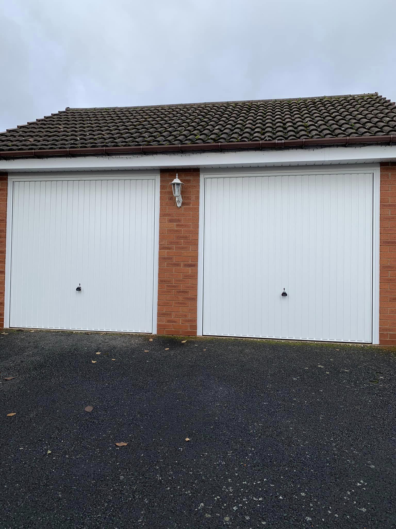 double garage with white up and over steel doors